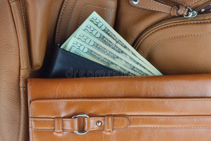 Money between Stack of Purses Stock Image Image of brown, dollar