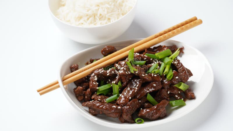 Mongolian meat in sauce with rice. Traditional Asian dish stir-fry. Mongolian meat in sauce with rice. Traditional Asian dish stir-fry