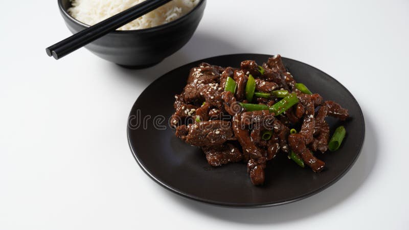 Mongolian meat in sauce with rice. Traditional Asian dish stir-fry. Mongolian meat in sauce with rice. Traditional Asian dish stir-fry