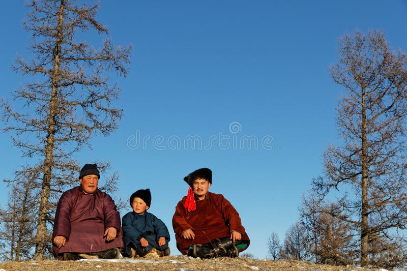 Mongolian people in traditional clothes in a forest landscape