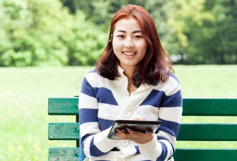 Mongolian woman sitting on a bench royalty free stock photo