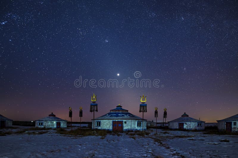 The Mongolian yurts in night starry sky in winter