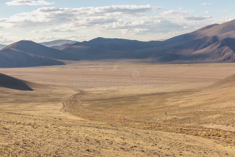 Mongolia landscape with nomad yurts, Mongolian nomad on a motorcycle. Mongolia landscape with nomad yurts, Mongolian nomad on a motorcycle