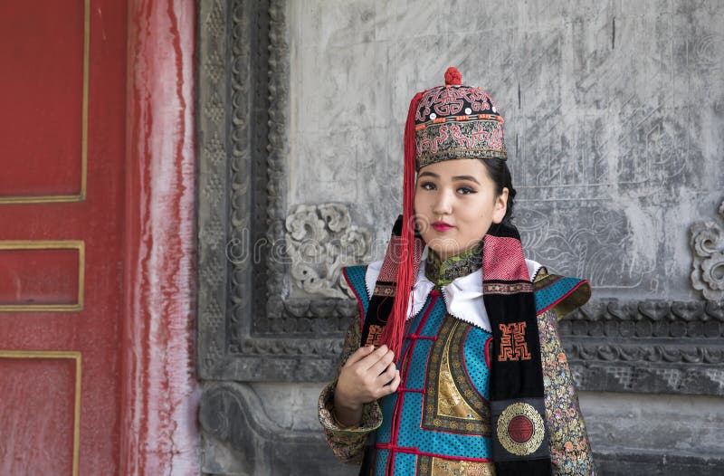 Mongolian woman in traditional outfit near old Temple in Ulaanbaatar. Mongolian woman in traditional outfit near old Temple in Ulaanbaatar