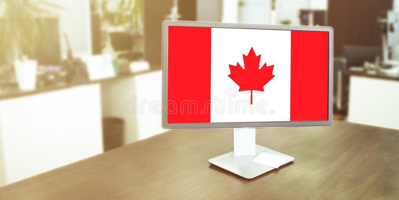 Monitor in modern office with Canada flag on the screen. BUSINESS
