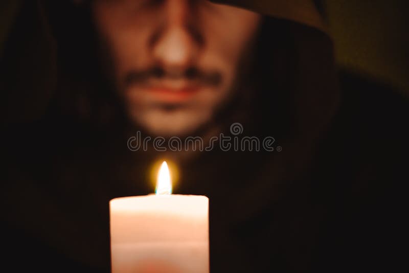 A monk with a candle stock image
