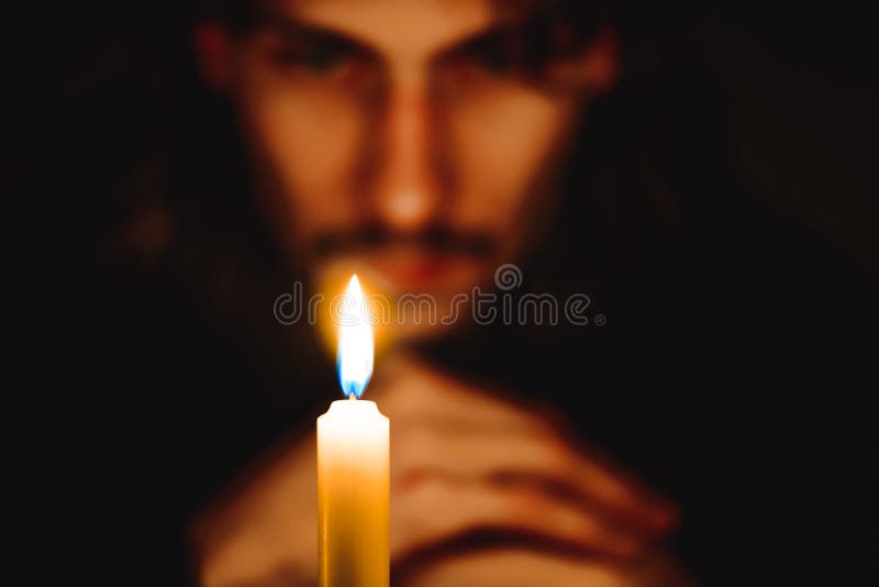 A monk with a candle stock images