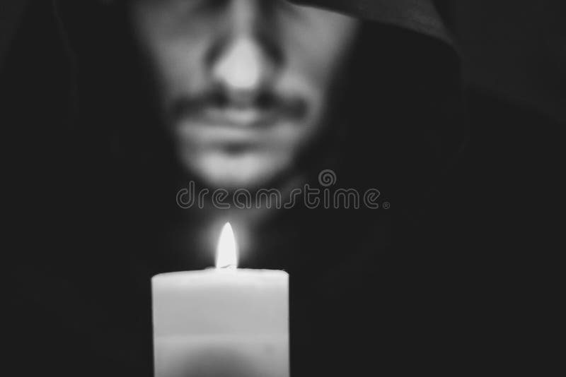 A monk with a candle stock image