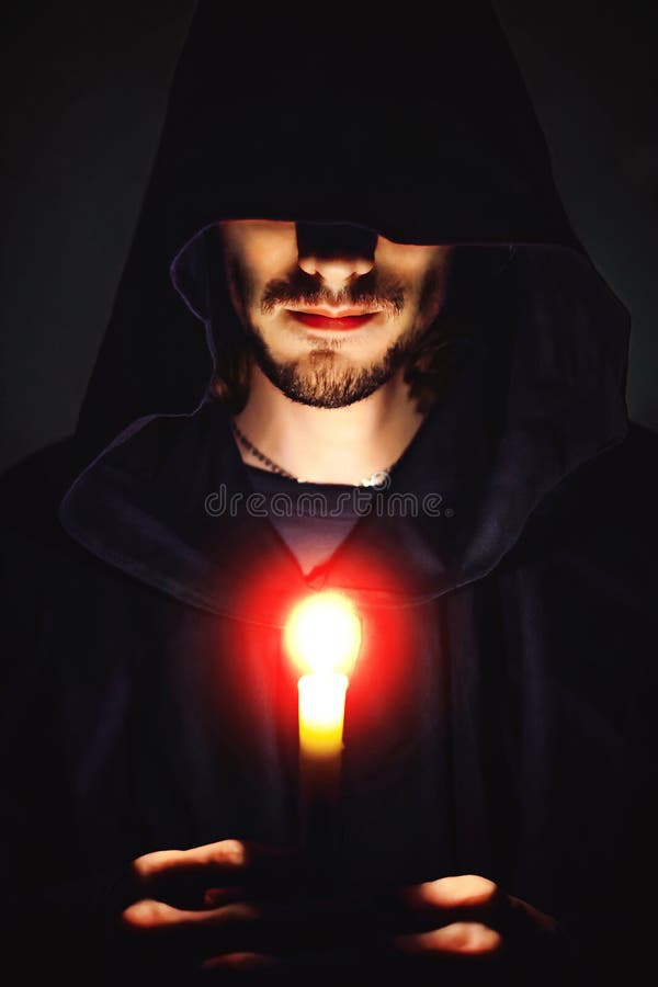 A monk with a candle royalty free stock image