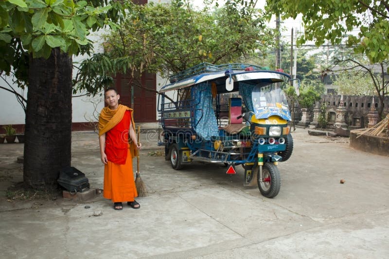 Monk with colorful Tuk Tuk in Laos, Luang Prabang