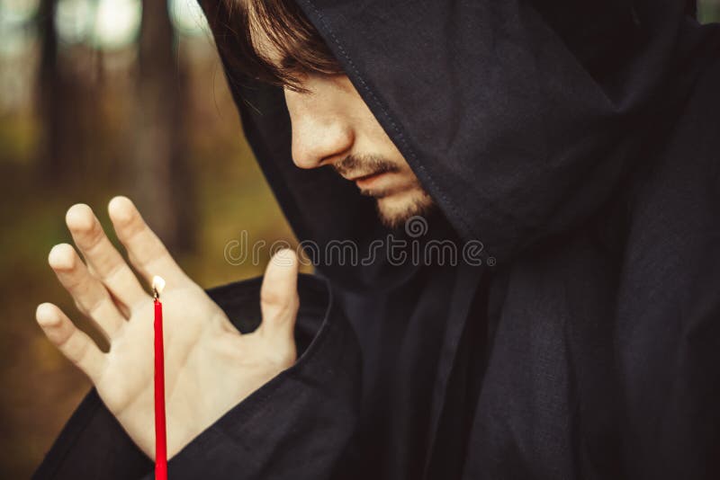 A monk with a candle stock image