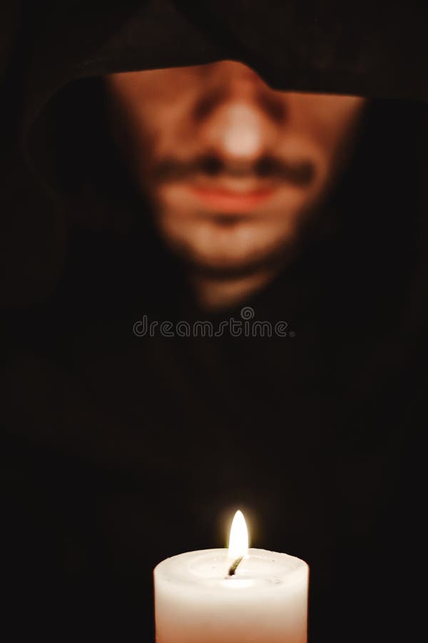 A monk with a candle stock photos