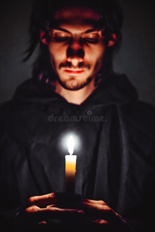 A monk with a candle royalty free stock photo