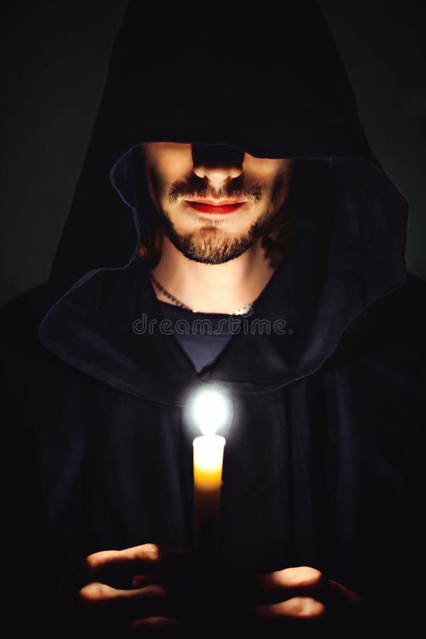 A monk with a candle stock image