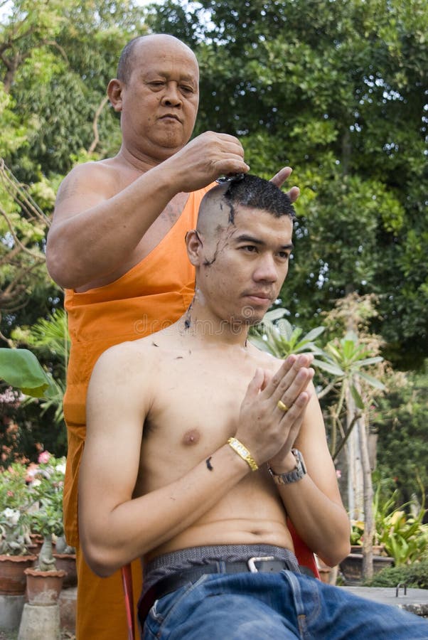 Monk shaving head royalty free stock image