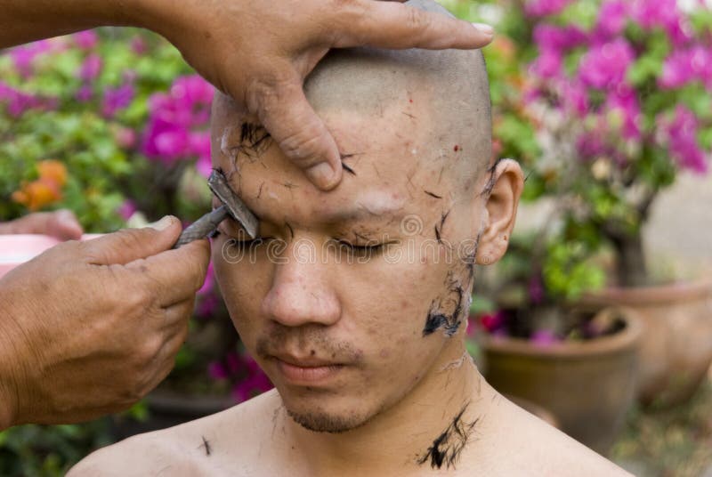 Monk shaving head royalty free stock photo