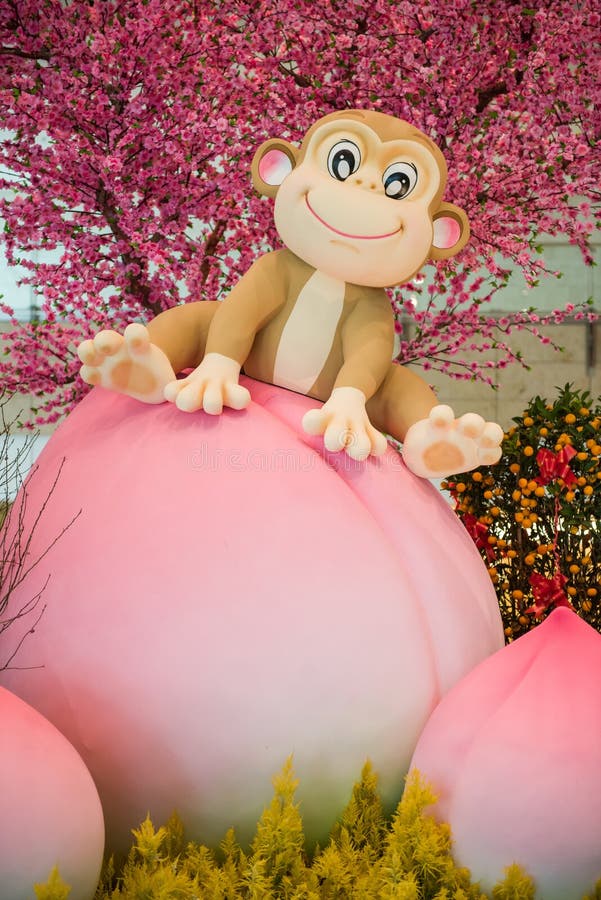Monkey mascot sitting on peach - Chinese New Year decoration stock photos Monkey mascot sitting on peach - Chinese New Year decoration stock photos