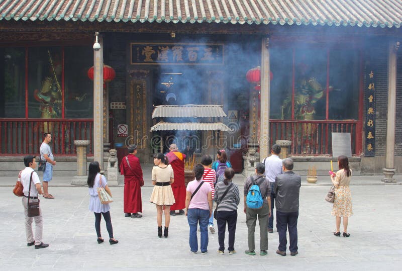 Praying Buddhist monks and devotion, Hualin temple, Guangzhou, China