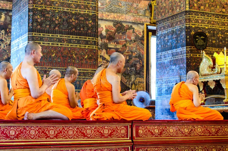 Monks pray in the evening in Wat Pho Temple