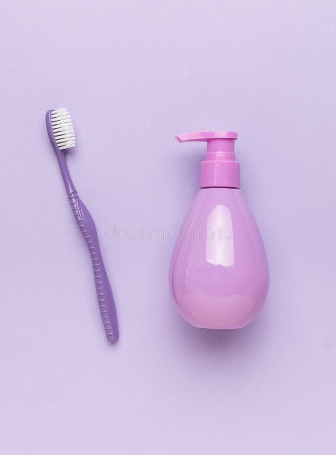 Monochrome image of toothpaste and toothbrush on a purple background stock photos