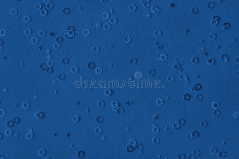 metallic foil confetti sparse on trendy blue colored background