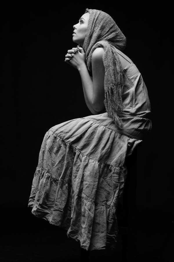 Monochrome portrait of praying woman