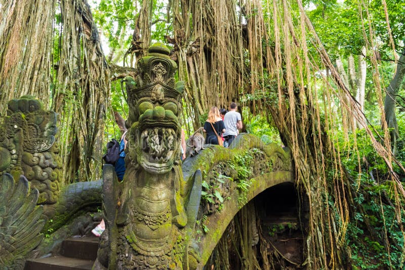 Bali, Indonesia - May 2, 2017: Macaque monkeys on Dragon Bridge at Ubud Sacred Monkey Forest Sanctuary, a nature reserve and Hindu temple complex in Ubud, Bali, Indonesia. Bali, Indonesia - May 2, 2017: Macaque monkeys on Dragon Bridge at Ubud Sacred Monkey Forest Sanctuary, a nature reserve and Hindu temple complex in Ubud, Bali, Indonesia.