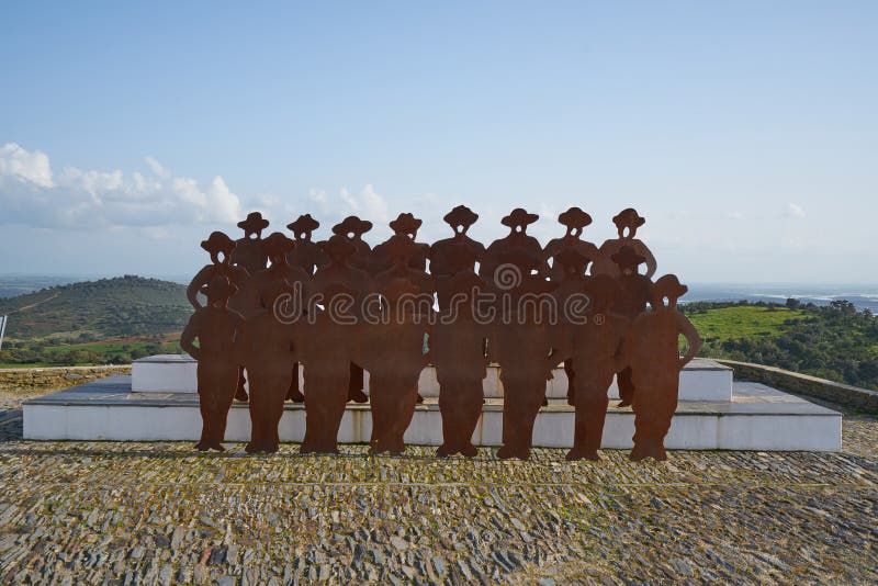 Monsaraz canto alentejano singing men with the village on the background in Alentejo, Portugal