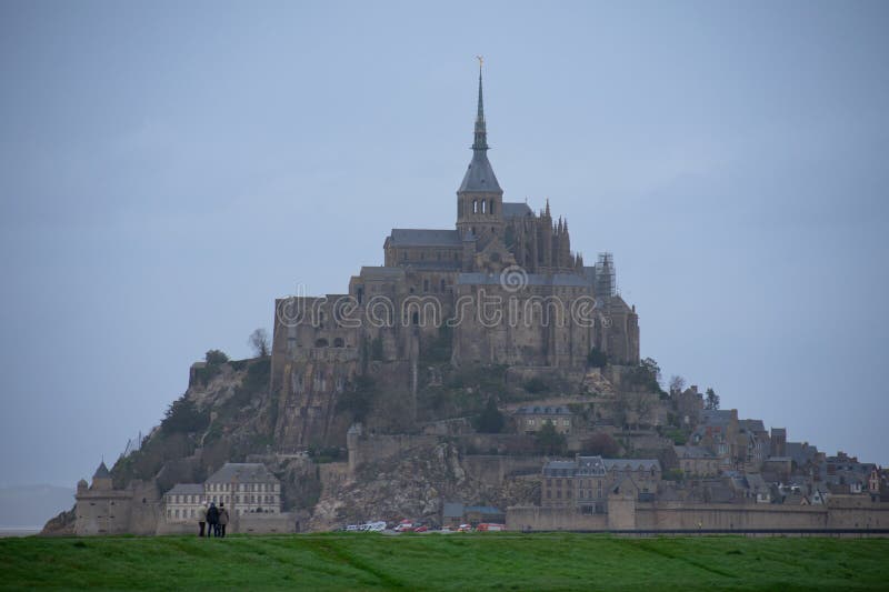 Mont Saint Michel from afar with green farmlands in foreground, Normandy region, France. Mont Saint Michel from afar with green farmlands in foreground, Normandy region, France