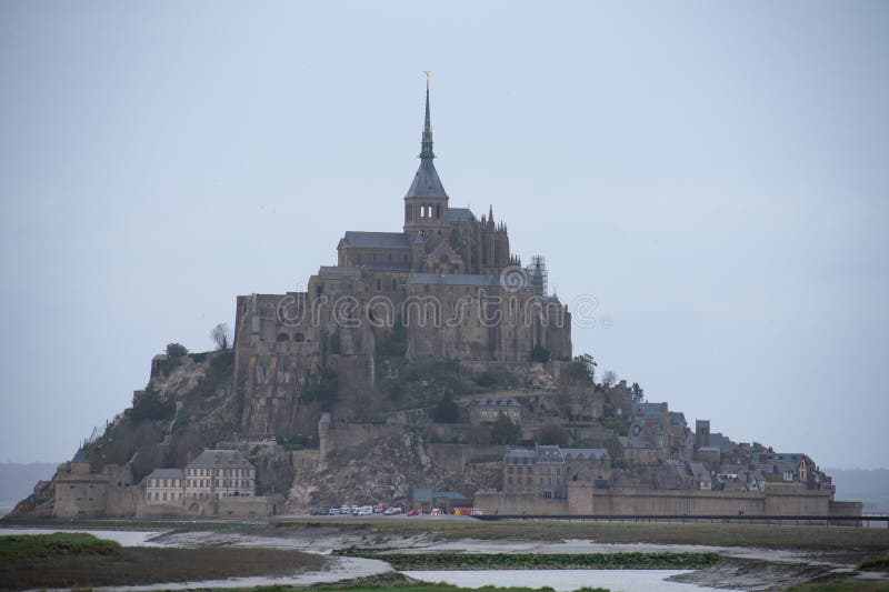 Mont Saint Michel from afar with green farmlands in foreground, Normandy region, France. Mont Saint Michel from afar with green farmlands in foreground, Normandy region, France