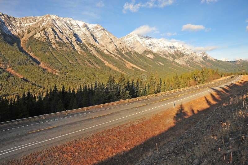 View of golden rocky mountains and highway in sunrise moment, kananaskis country, alberta, canada. View of golden rocky mountains and highway in sunrise moment, kananaskis country, alberta, canada