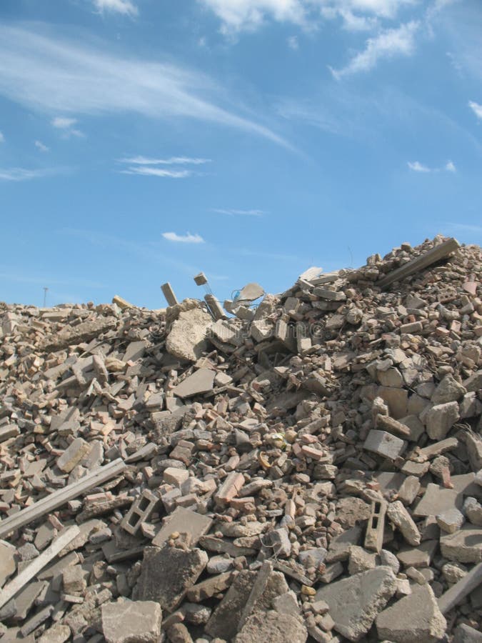 A huge pile of concrete rubble against a lovely blue sky. A huge pile of concrete rubble against a lovely blue sky.