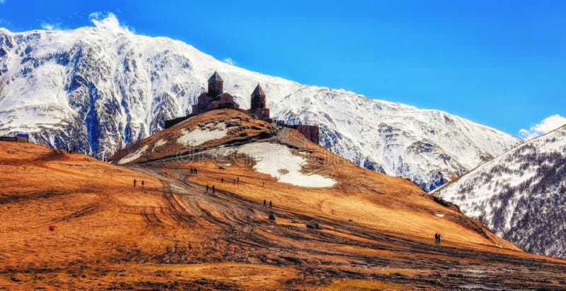 Montagne di Caucaso, chiesa di trinità antica di Gergeti Tsminda Sameb immagine stock Montagne di Caucaso, chiesa di trinità antica di Gergeti Tsminda Sameb immagine stock