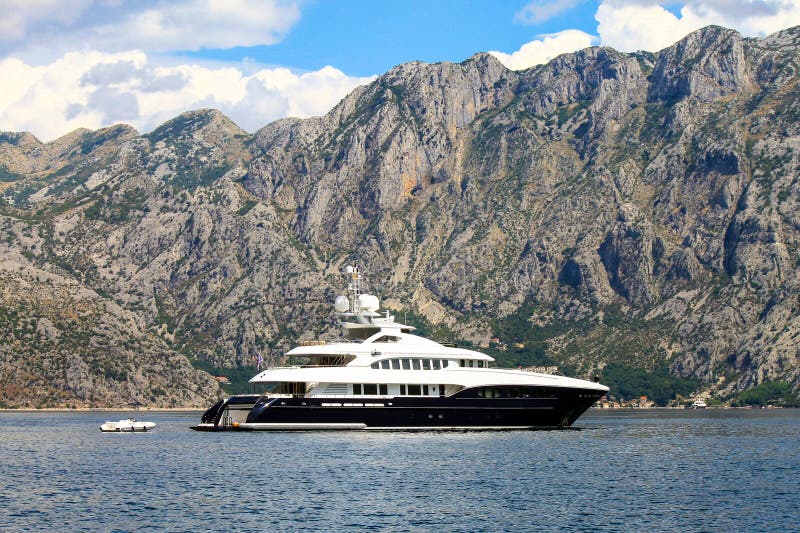 Montenegro. Large white yacht sails in the Bay of Kotor near the town of Herceg Novi stock photo Montenegro. Large white yacht sails in the Bay of Kotor near the town of Herceg Novi stock photo