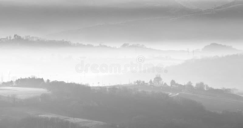 Soft hills between the morning fog in black and white. Soft hills between the morning fog in black and white