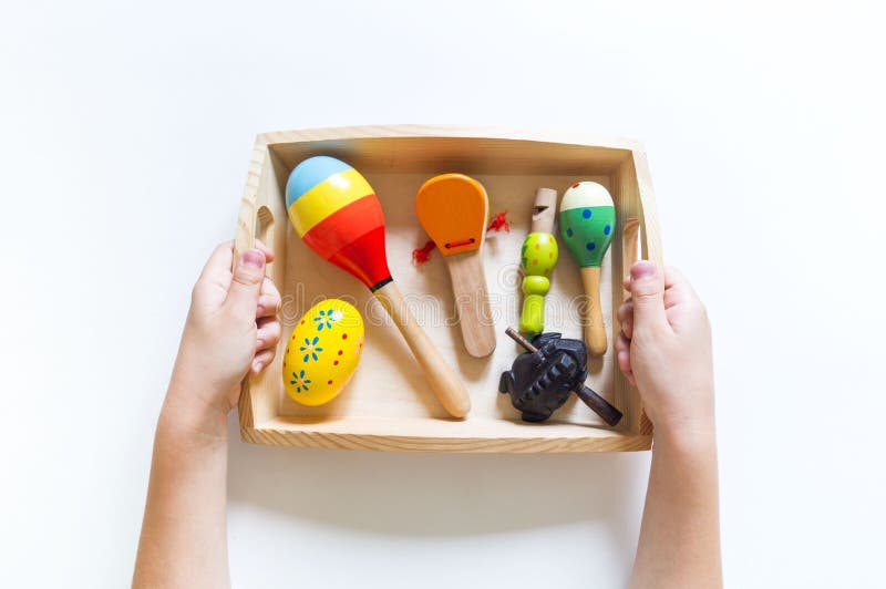 Montessori material. Children`s hands. The study of music