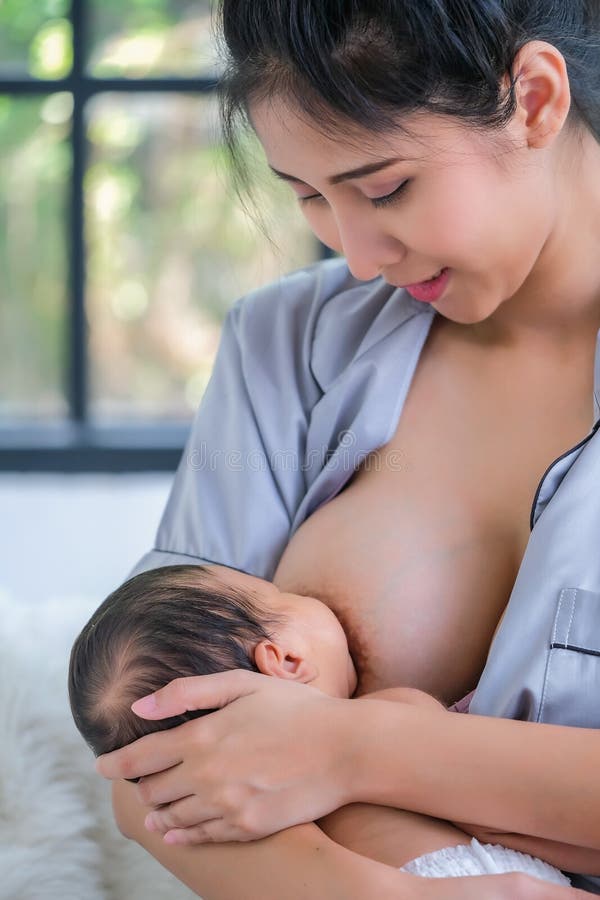 1.5 Month Old Asian Baby is Happy To Suck Breast Milk Stock Image