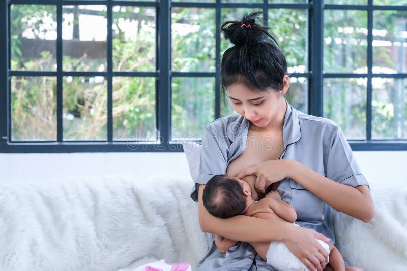 1.5 Month Old Asian Baby is Happy To Suck Breast Milk Stock Image