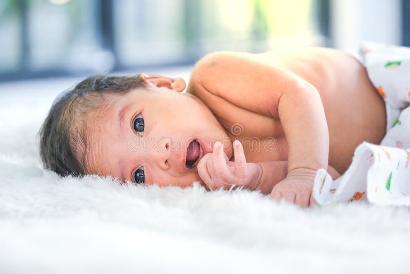 2monthold Babies Lie on the White Cloth and the Morning Sun Stock