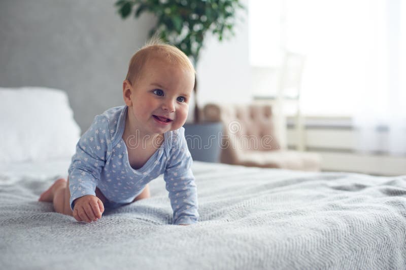 month old happy baby boy crawling bed home 128007713