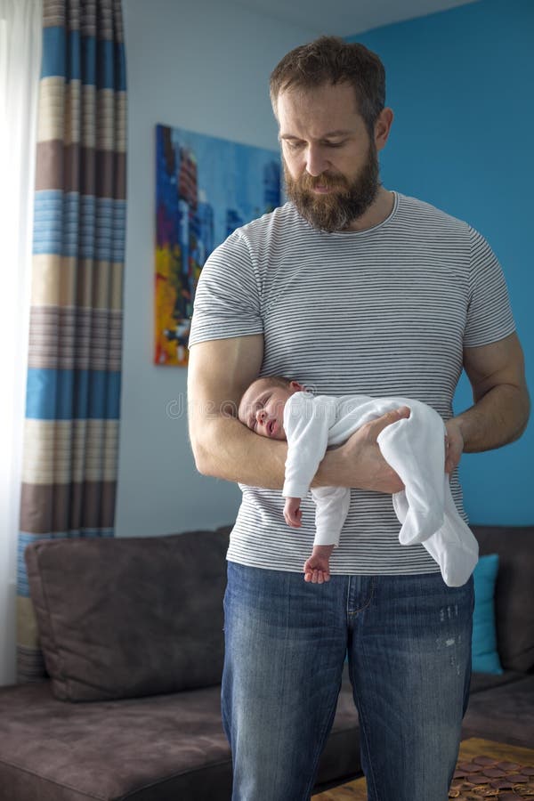 Monthly baby sleeping on the arm. Of his father's hand, position to help colic Monthly baby sleeping on the arm. Of his father's hand, position to help colic