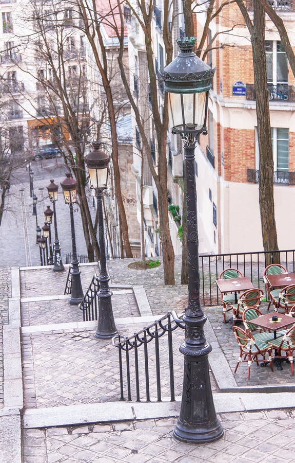 Montmartre staircase, street lamps and cafÃ© in Paris.