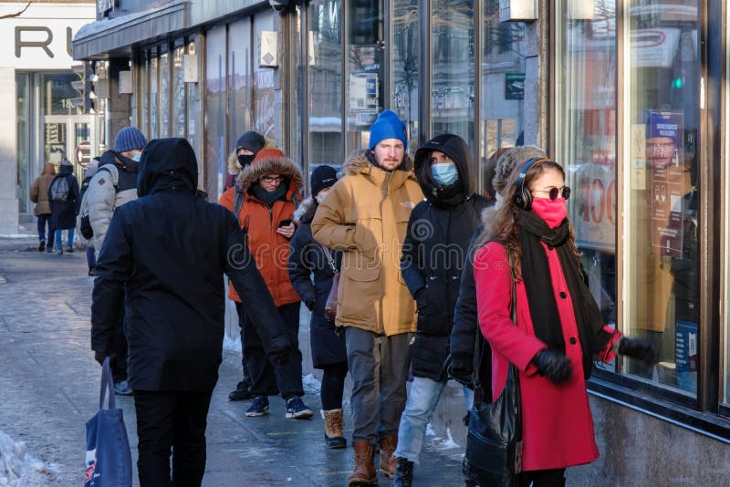 Customers in a line outside of SAQ liquor store in Montreal