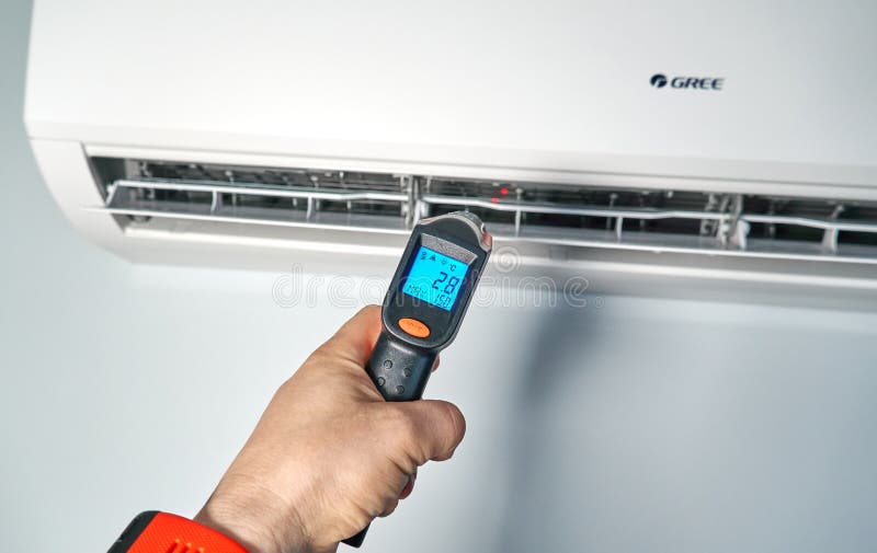 Technitian Checking Temperature by Infrared Thermometer Inside of Gree