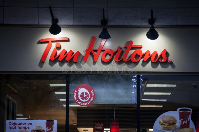 MONTREAL, CANADA - NOVEMBER 6, 2018: Tim Hortons Logo In Front Of One Of  Their Restaurants In Quebec With Their Slogan In French In The Background. Tim  Hortons Is A Cafe And