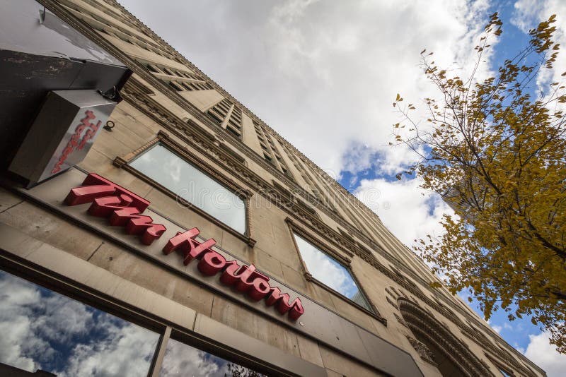 MONTREAL, CANADA - NOVEMBER 6, 2018: Tim Hortons Logo In Front Of One Of  Their Restaurants In Quebec With Their Slogan In French In The Background. Tim  Hortons Is A Cafe And