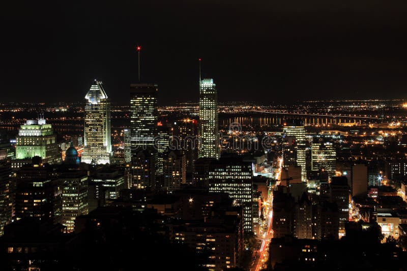 City of Montreal at night viewed from the mont Royal during summer. The landscape color photograph shows the metropolis skyline with the Saint-Laurence river and the south shore in the background after dark. Taken in August 2012. Window color reflection background stock images, royalty-free photos and pictures