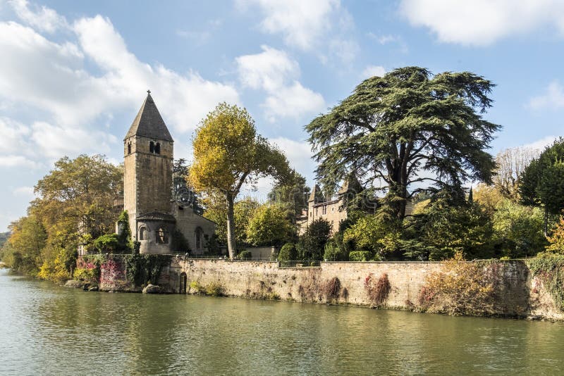 Monumental church tower on the island Ile Barbe in the Saone, in