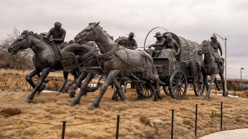 Pictured is the `Centennial Land Run Monument` by artist Paul Moore in Oklahoma City, Oklahoma. The monument commemorates the opening of the Unassigned Land in Oklahoma Territory with the Land Run of 1889. It is one of the worldâ€™s largest bronze sculptures featuring 45 heroic figures of land run participants as they race to claim new homesteads.  The monument is a city park and is open to the public year around 2r hours a day with free admission.  The sculptures were created from bronze and stainless steel between April 2003 and 2015. Pictured is the `Centennial Land Run Monument` by artist Paul Moore in Oklahoma City, Oklahoma. The monument commemorates the opening of the Unassigned Land in Oklahoma Territory with the Land Run of 1889. It is one of the worldâ€™s largest bronze sculptures featuring 45 heroic figures of land run participants as they race to claim new homesteads.  The monument is a city park and is open to the public year around 2r hours a day with free admission.  The sculptures were created from bronze and stainless steel between April 2003 and 2015.