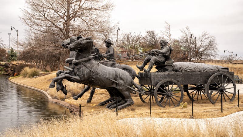 Pictured is the `Centennial Land Run Monument` by artist Paul Moore in Oklahoma City, Oklahoma. The monument commemorates the opening of the Unassigned Land in Oklahoma Territory with the Land Run of 1889. It is one of the worldâ€™s largest bronze sculptures featuring 45 heroic figures of land run participants as they race to claim new homesteads.  The monument is a city park and is open to the public year around 2r hours a day with free admission.  The sculptures were created from bronze and stainless steel between April 2003 and 2015. Pictured is the `Centennial Land Run Monument` by artist Paul Moore in Oklahoma City, Oklahoma. The monument commemorates the opening of the Unassigned Land in Oklahoma Territory with the Land Run of 1889. It is one of the worldâ€™s largest bronze sculptures featuring 45 heroic figures of land run participants as they race to claim new homesteads.  The monument is a city park and is open to the public year around 2r hours a day with free admission.  The sculptures were created from bronze and stainless steel between April 2003 and 2015.